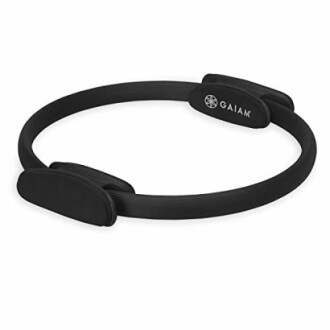 Black Pilates ring with padded handles.