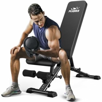 Man exercising with dumbbell on adjustable weight bench