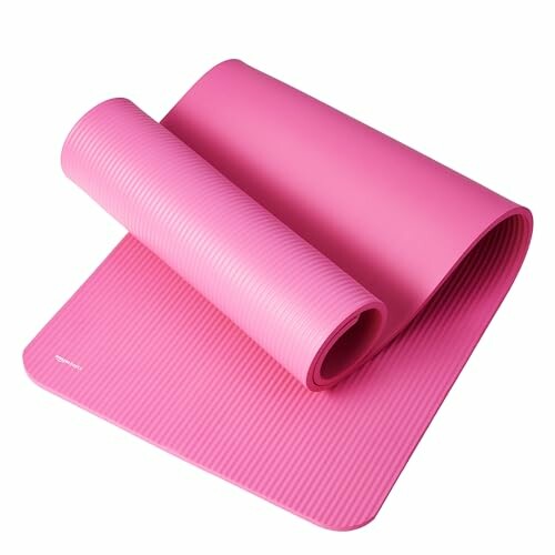 Pink rolled yoga mat on a white background